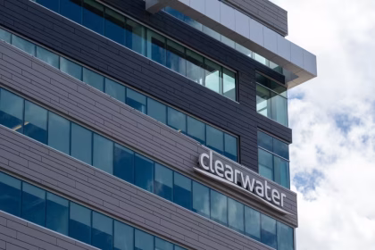 Modern glass office building with gray panels and a curved Clearwater sign on the facade