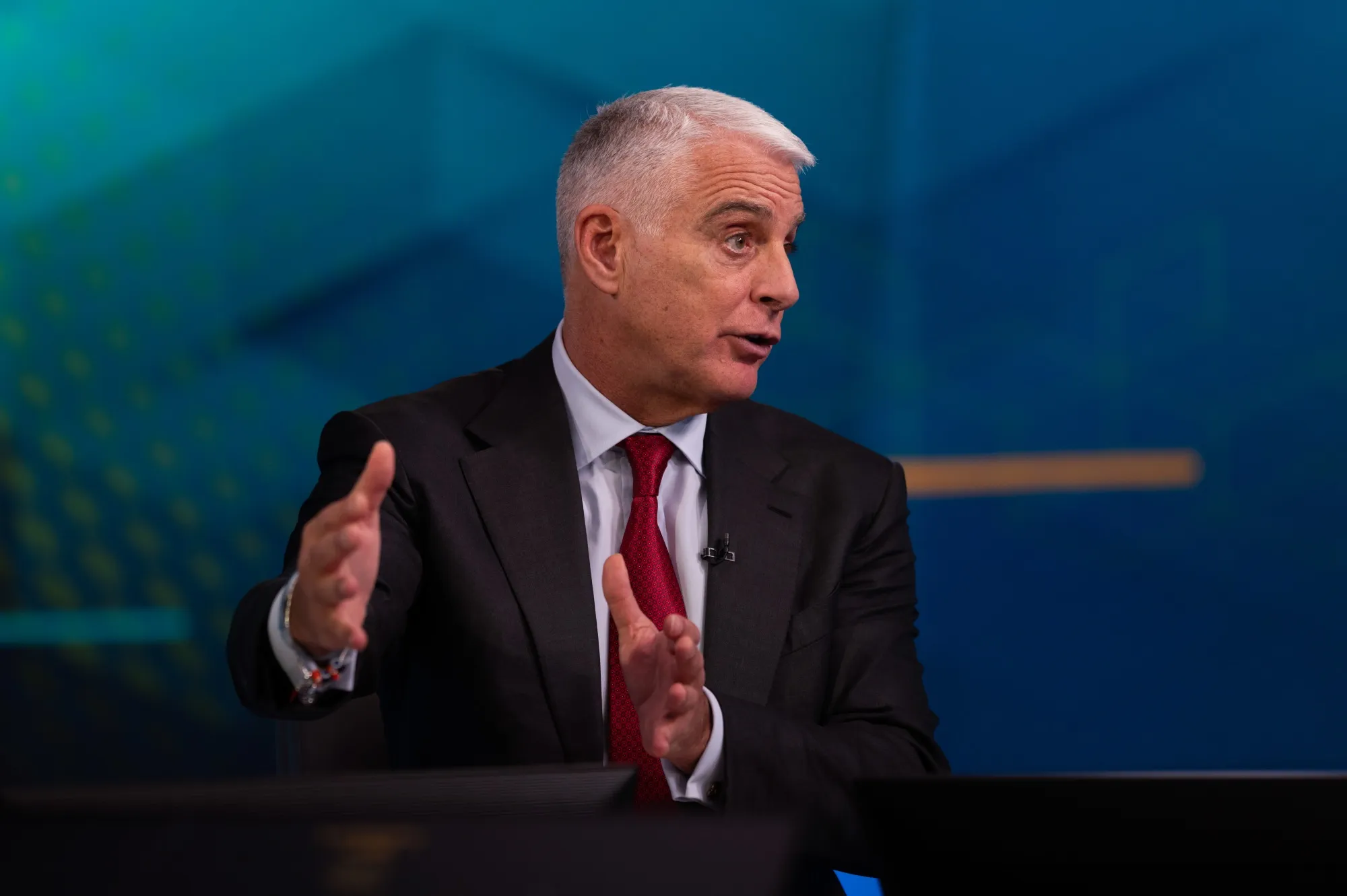 UniCredit CEO Andrea Orcel gesturing during a television interview