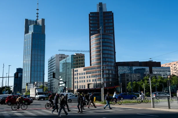 Warsaw skyline with pedestrians crossing the street
